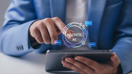 Business professional tapping tablet with Agentic AI interface, showing autonomous AI agents connected in a digital network.