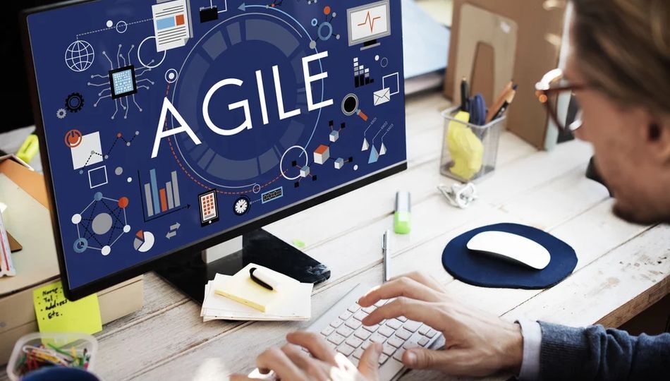 Agile outsourcing for startups shown through a monitor displaying agile methodology icons and charts.