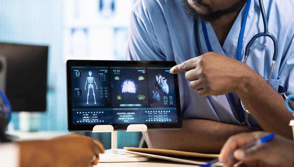 Doctor pointing at tablet displaying AI-analyzed medical scans, representing healthcare AI adoption and enterprise implementation.