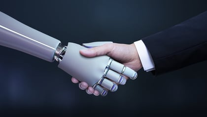 Robotic hand shaking a businessman's hand, symbolizing partnership between human expertise and AI strategy consulting.