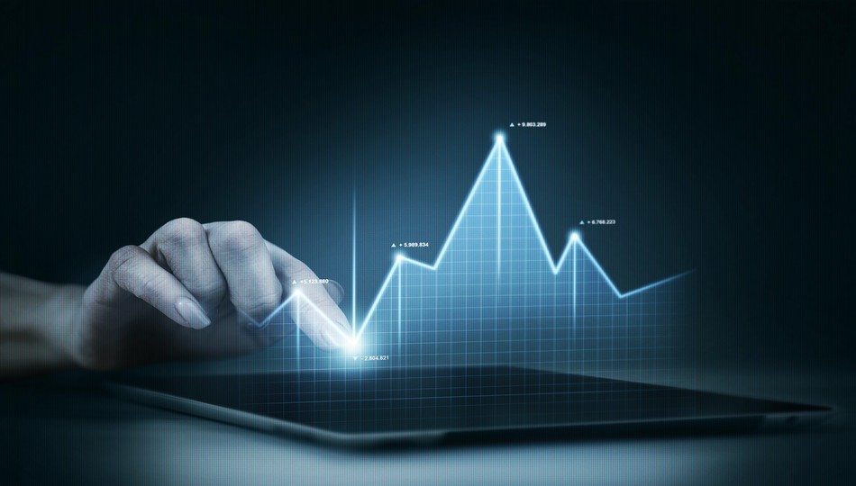 Hand interacting with a glowing holographic stock market growth graph, representing emerging application modernization trends