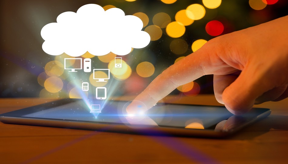 Hand tapping a tablet screen with cloud computing icons showing devices connecting to the cloud, representing enterprise cloud migration strategy
