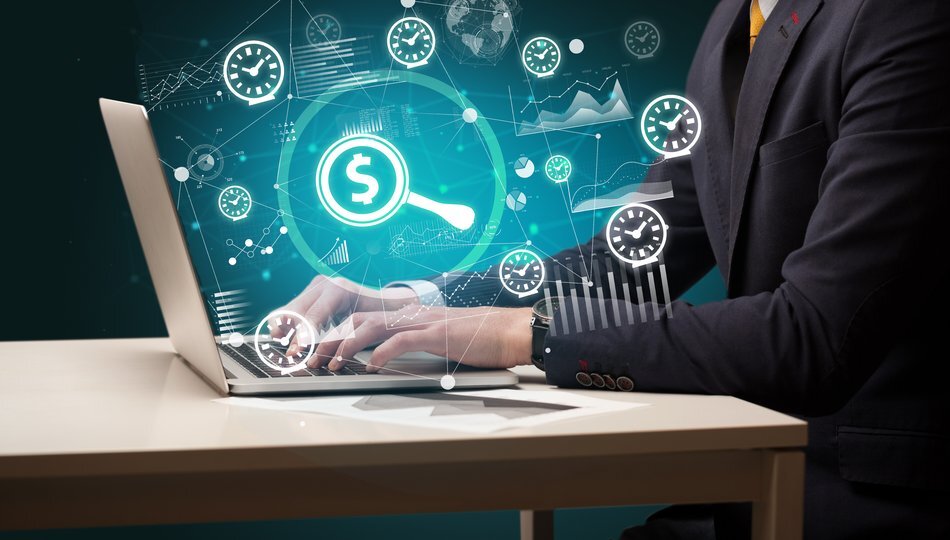 Cost of outsourcing software development represented by hands typing on laptop with dollar and clock icons.