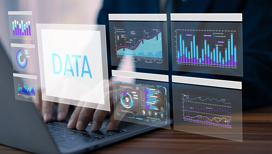 Businessman typing on laptop surrounded by data dashboards and analytics charts on screen.