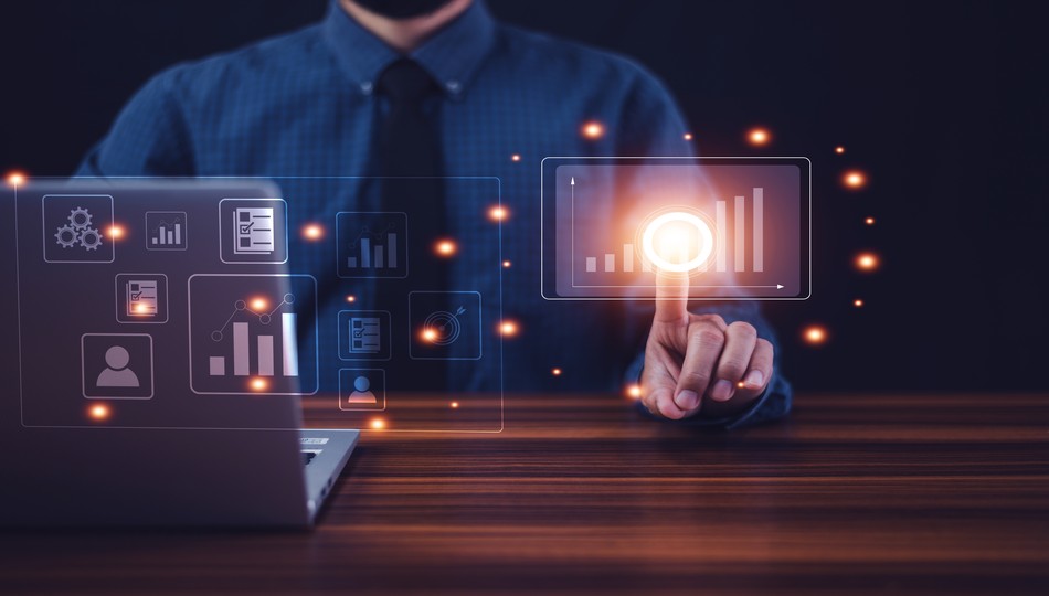 Businessman touching a glowing bar chart icon with dashboard analytics and data icons displayed on a laptop, representing measuring digital transformation ROI