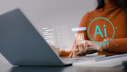 Woman typing AI command prompts on laptop, illustrating the comparison between generative AI and agentic AI systems.