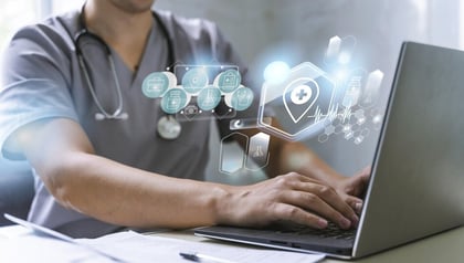 Doctor typing on laptop with medical and healthcare technology icons overlaid on screen.