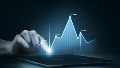 Hand touching a rising holographic financial chart on a tablet, illustrating how to measure AI return on investment.