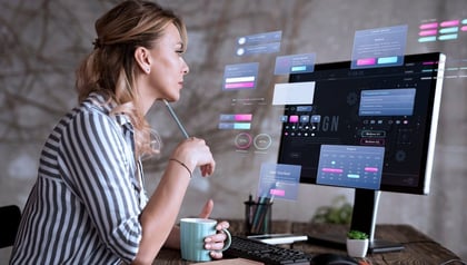 HR software development shown by a woman reviewing UI design elements on a computer screen.