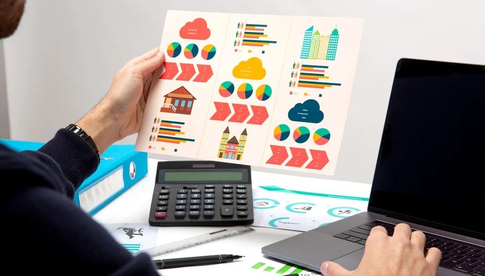 MVP development cost analysis shown through a person reviewing infographics with a calculator and laptop.
