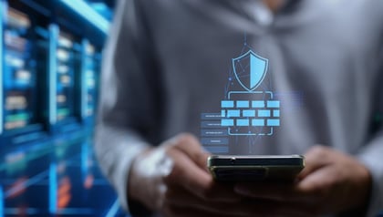 SaaS application security shown by a person on a phone with shield, firewall, and password icons.