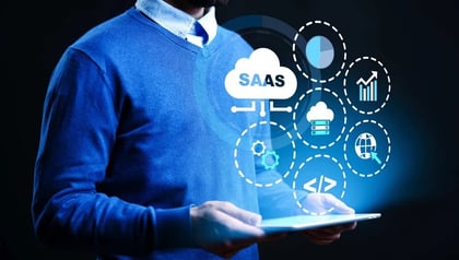 SaaS development lifecycle shown by a man holding a tablet with SaaS cloud and development icons.