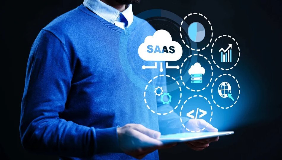 SaaS development lifecycle shown by a man holding a tablet with SaaS cloud and development icons.