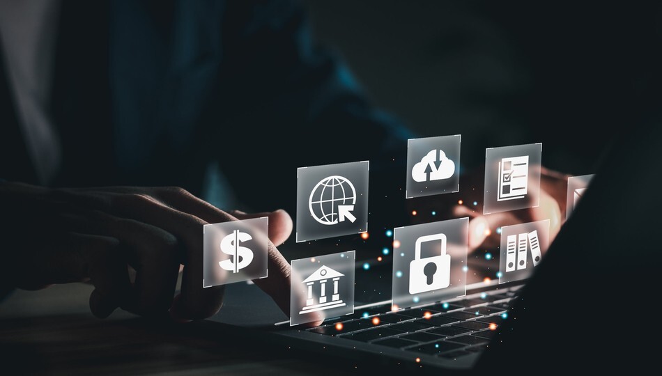 Fintech SaaS product shown by hands typing on a laptop with finance, cloud, and security icons.